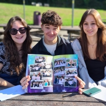 Lola, Archie and Emily celebrate great GCSE results and enjoy looking through the school yearbook